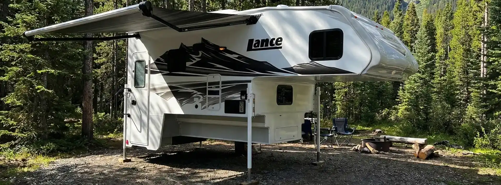 Lance Truck Camper on pickup truck in mountain landscape