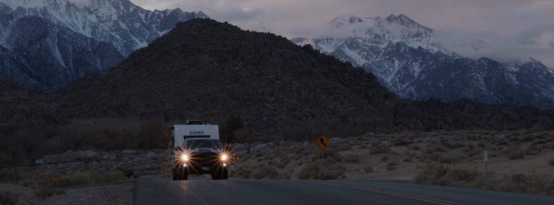 Lance Travel Trailer parked at scenic lakeside campsite